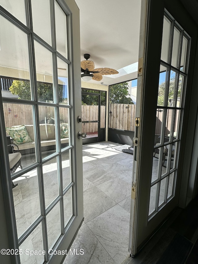 entryway with ceiling fan and plenty of natural light