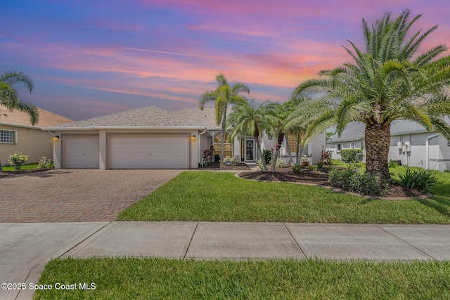 3156 Quint Dr, Melbourne, FL 32940 - single story home featuring decorative driveway, a garage, stucco siding, and a front yard