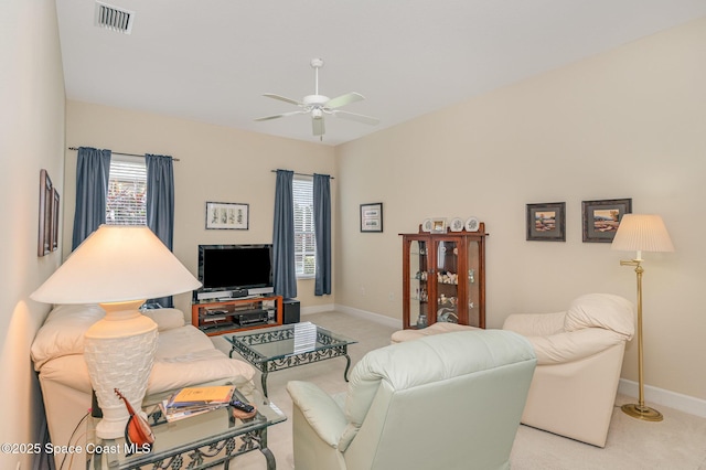 3156 Quint Dr, Melbourne, FL 32940 - living area with light carpet, a ceiling fan, and baseboards
