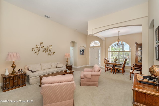3156 Quint Dr, Melbourne, FL 32940 - carpeted living room with arched walkways, a chandelier, and baseboards