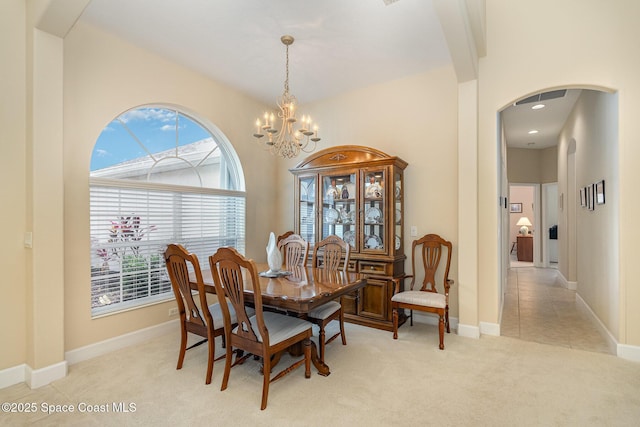 3156 Quint Dr, Melbourne, FL 32940 - dining room with arched walkways, a chandelier, plenty of natural light, and light carpet