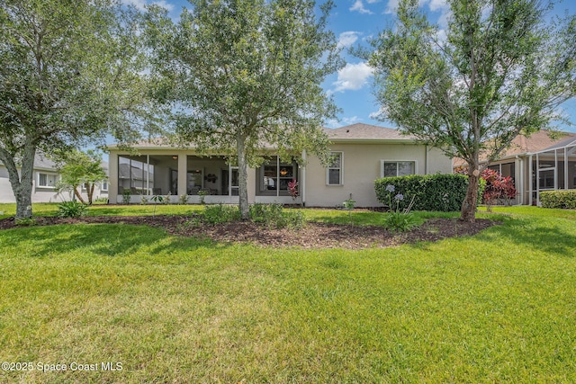 3156 Quint Dr, Melbourne, FL 32940 - back of property featuring a sunroom, stucco siding, and a yard
