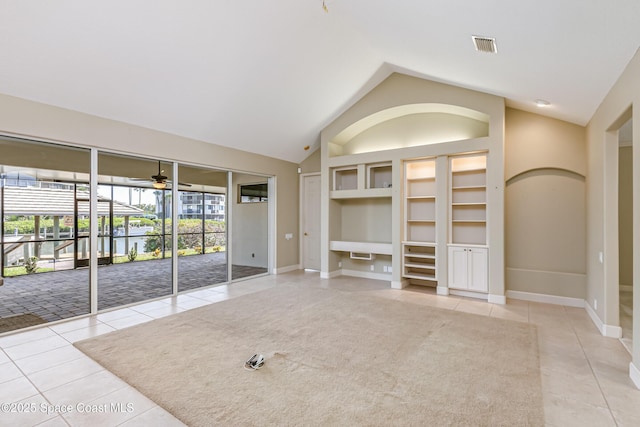 603 Manatee Bay Dr, Cape Canaveral, FL 32920 - unfurnished living room featuring light tile patterned floors, built in shelves, ceiling fan, vaulted ceiling, and baseboards
