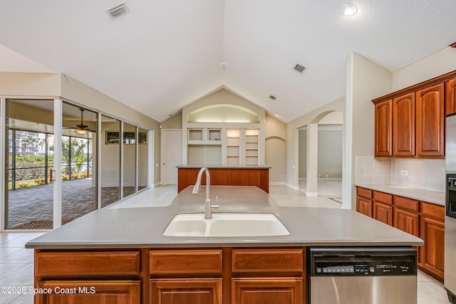 603 Manatee Bay Dr, Cape Canaveral, FL 32920 - kitchen featuring a sink, stainless steel dishwasher, an island with sink, built in features, and vaulted ceiling