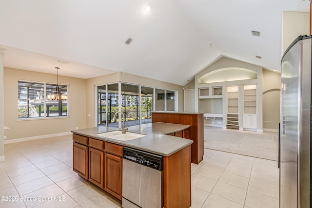 603 Manatee Bay Dr, Cape Canaveral, FL 32920 - kitchen with a sink, appliances with stainless steel finishes, light tile patterned floors, a center island with sink, and brown cabinets