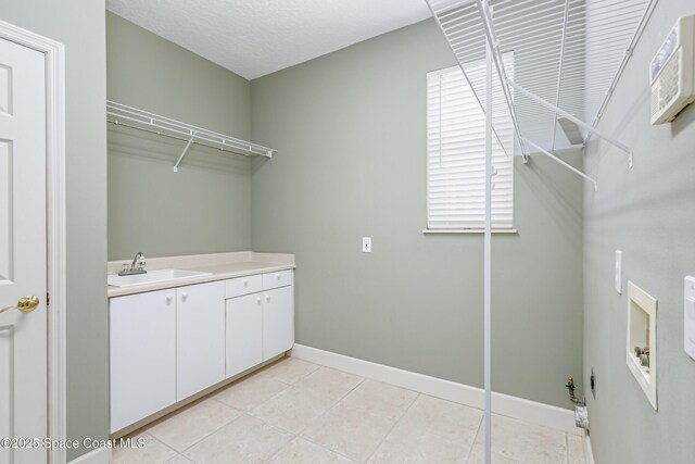 603 Manatee Bay Dr, Cape Canaveral, FL 32920 - washroom featuring cabinet space, baseboards, light tile patterned floors, and hookup for a washing machine