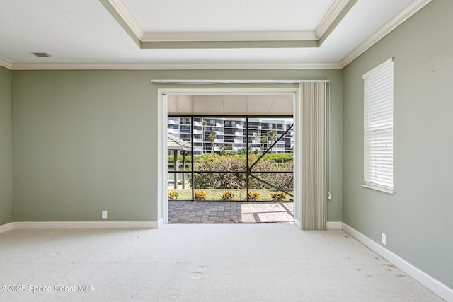 603 Manatee Bay Dr, Cape Canaveral, FL 32920 - carpeted empty room featuring crown molding, a raised ceiling, and baseboards