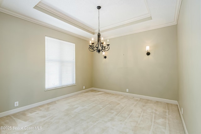 603 Manatee Bay Dr, Cape Canaveral, FL 32920 - spare room with crown molding, a tray ceiling, a chandelier, light colored carpet, and baseboards