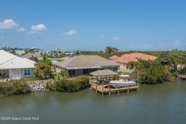 603 Manatee Bay Dr, Cape Canaveral, FL 32920 - dock featuring boat lift and a water view