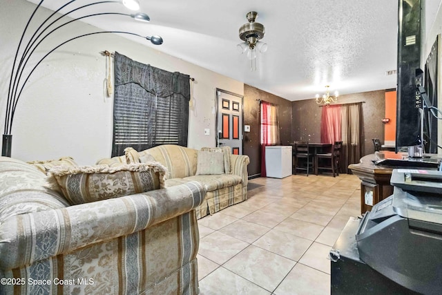 living room featuring tile patterned floors and a notable chandelier