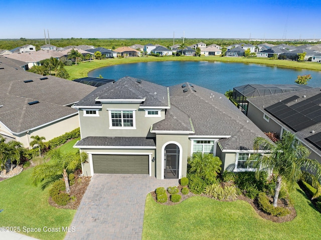 view of front of property featuring stucco siding, an attached garage, decorative driveway, and a residential view