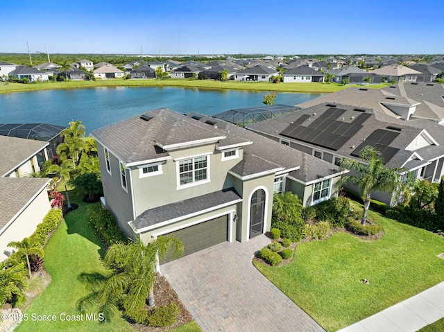 drone / aerial view with a water view and a residential view