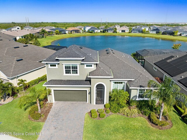 view of front of property featuring stucco siding, an attached garage, decorative driveway, and a residential view