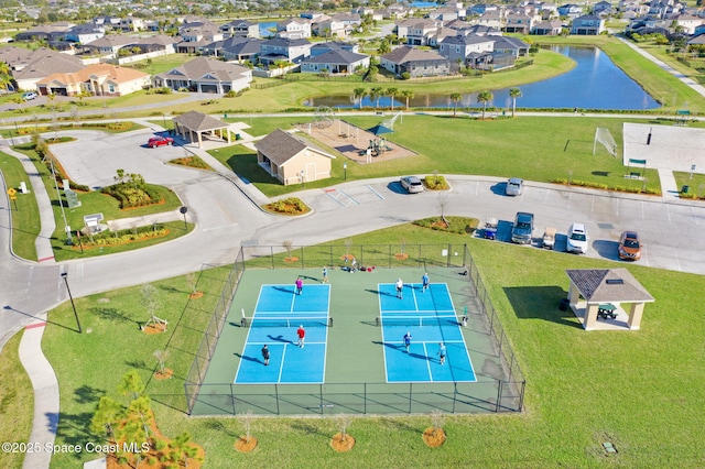 drone / aerial view featuring a residential view and a water view