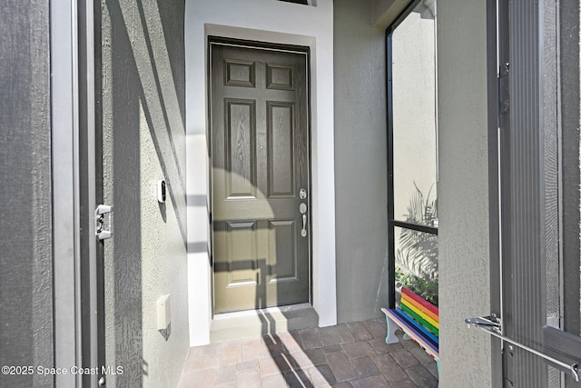 doorway to property with stucco siding