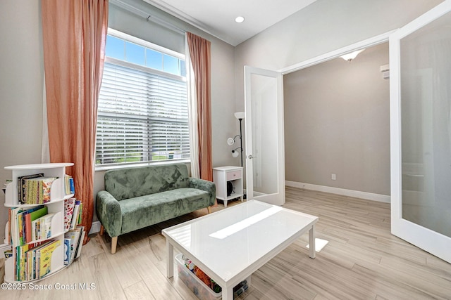 sitting room with baseboards, light wood-style floors, and recessed lighting