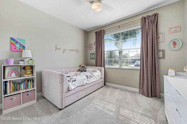 carpeted bedroom featuring ceiling fan and baseboards