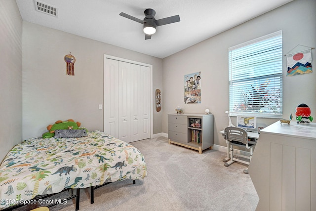 bedroom featuring carpet flooring, baseboards, visible vents, a closet, and ceiling fan