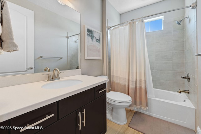 bathroom with wood finished floors, toilet, vanity, and shower / bathtub combination with curtain