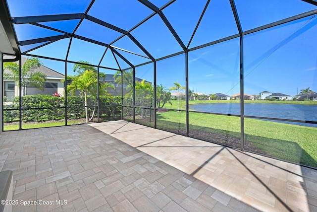 unfurnished sunroom with a residential view and a water view
