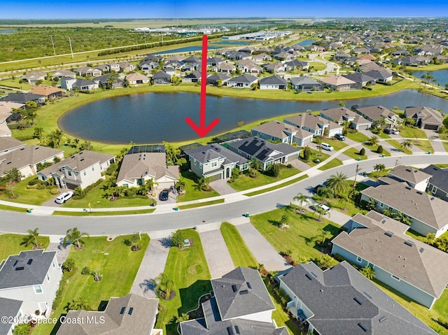 drone / aerial view featuring a residential view and a water view