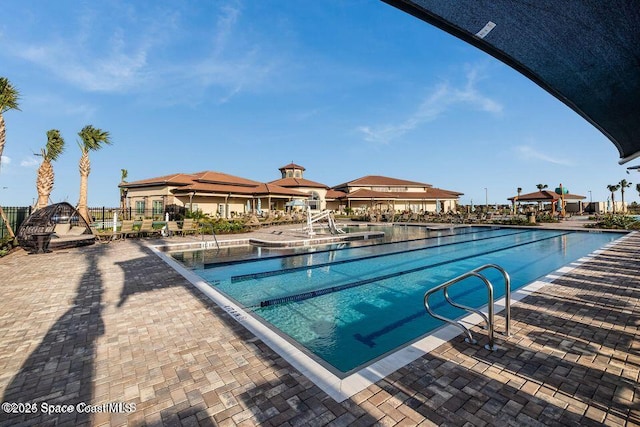 community pool with a patio and a gazebo