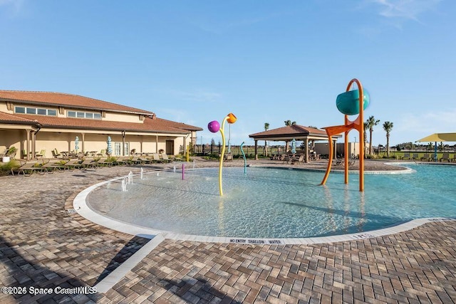 view of pool featuring playground community