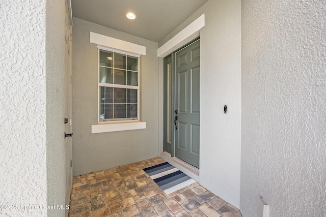 property entrance featuring stucco siding