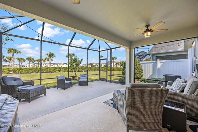 view of patio with an outdoor living space, a lanai, and a ceiling fan