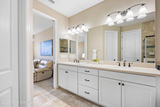 full bath featuring a sink, a shower stall, and double vanity