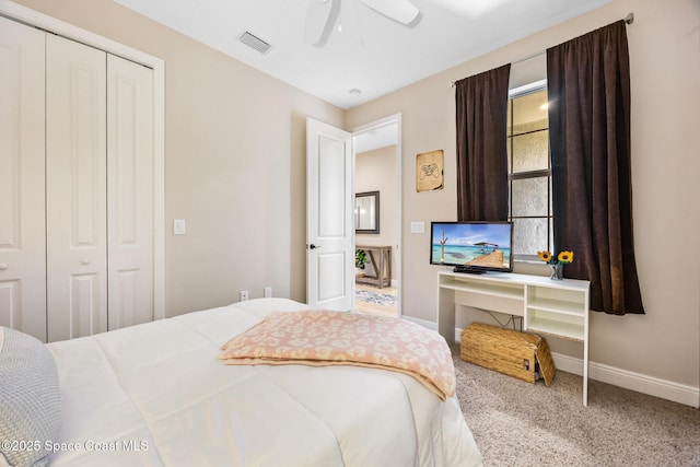 bedroom with carpet, visible vents, a closet, baseboards, and ceiling fan