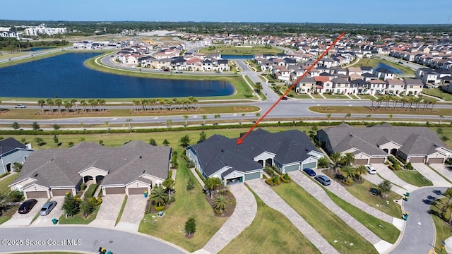 drone / aerial view featuring a residential view and a water view