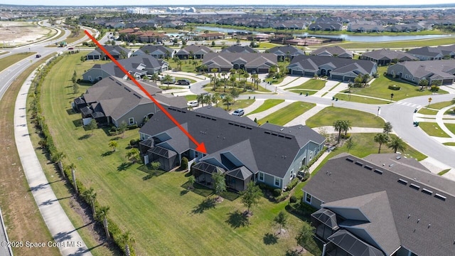 birds eye view of property with a residential view and a water view