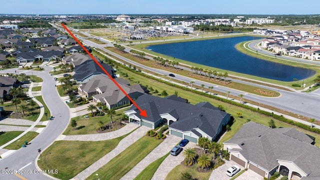 birds eye view of property featuring a water view and a residential view