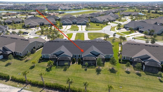 bird's eye view with a residential view and a water view