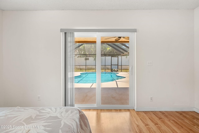 36 Mohican Way, Melbourne Beach, FL 32951 - bedroom with access to exterior, wood finished floors, and baseboards
