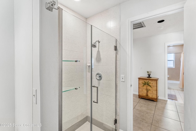 36 Mohican Way, Melbourne Beach, FL 32951 - bathroom featuring a shower stall, tile patterned flooring, and baseboards