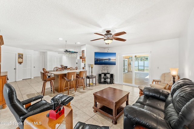 36 Mohican Way, Melbourne Beach, FL 32951 - living area featuring a ceiling fan, light tile patterned floors, and a textured ceiling