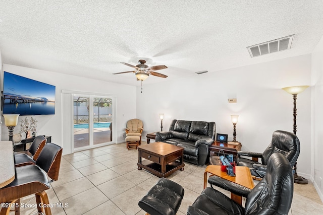 36 Mohican Way, Melbourne Beach, FL 32951 - living area with a ceiling fan, a textured ceiling, and light tile patterned flooring