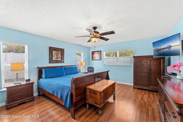 36 Mohican Way, Melbourne Beach, FL 32951 - bedroom featuring wood finished floors, baseboards, a textured ceiling, and a ceiling fan