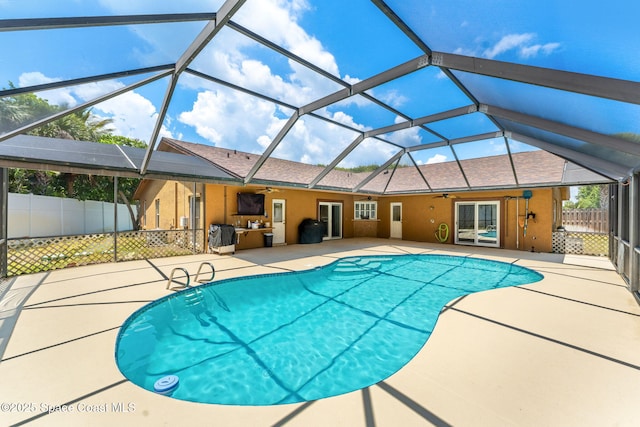 36 Mohican Way, Melbourne Beach, FL 32951 - view of swimming pool with a ceiling fan, a patio, fence, and a lanai