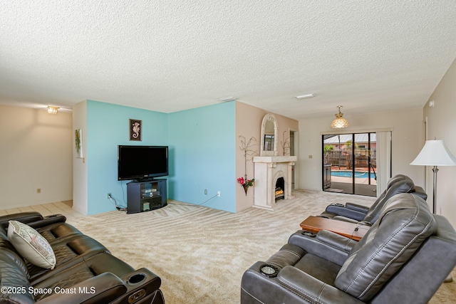 265 Sheridan Ave, Satellite Beach, FL 32937 - living room featuring carpet flooring, a textured ceiling, and a warm lit fireplace