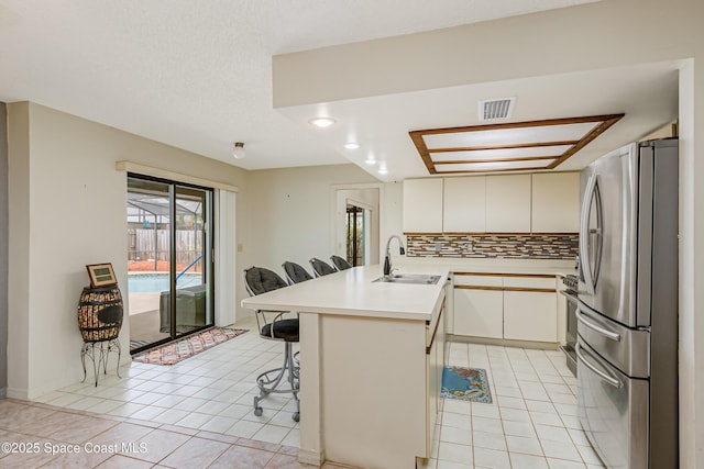 265 Sheridan Ave, Satellite Beach, FL 32937 - kitchen featuring stainless steel appliances, a peninsula, light tile patterned flooring, and visible vents