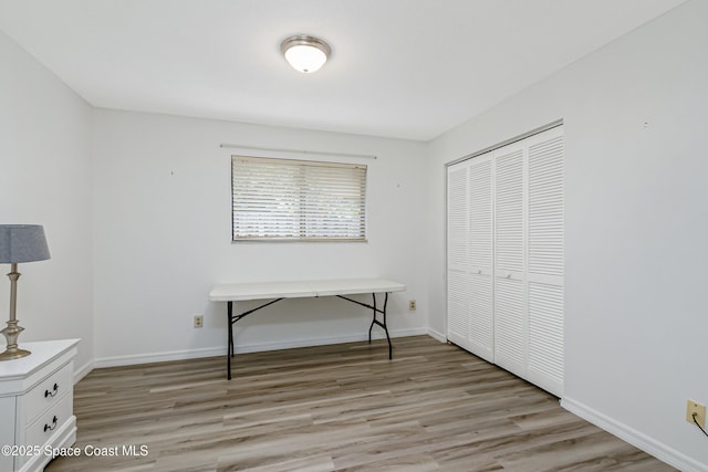 265 Sheridan Ave, Satellite Beach, FL 32937 - unfurnished bedroom featuring baseboards, a closet, and light wood-style flooring