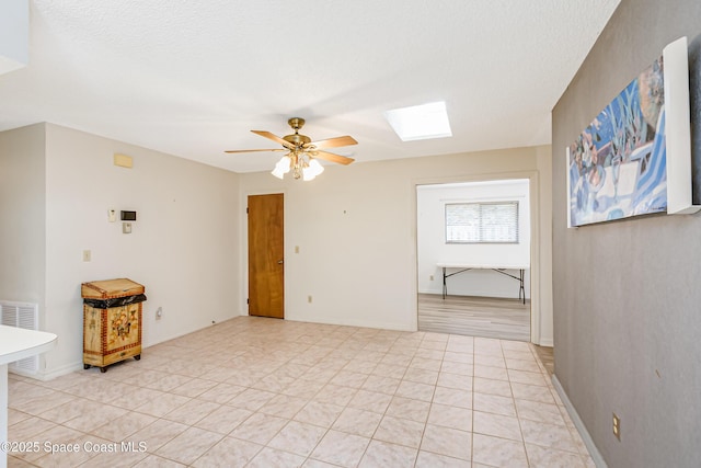 265 Sheridan Ave, Satellite Beach, FL 32937 - empty room featuring a skylight, baseboards, a ceiling fan, and visible vents