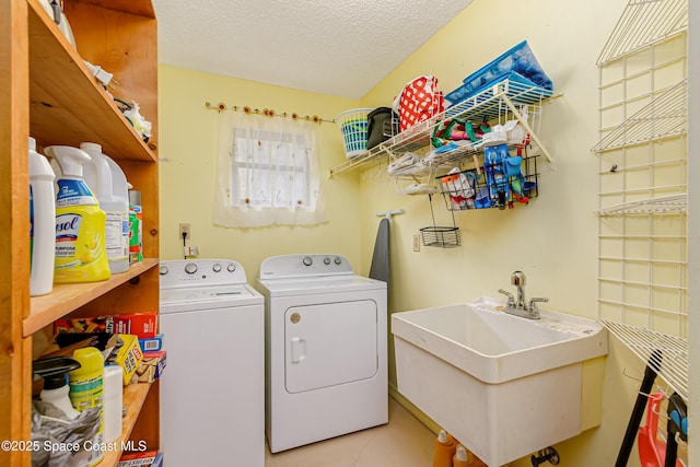 265 Sheridan Ave, Satellite Beach, FL 32937 - clothes washing area with laundry area, a sink, a textured ceiling, and washing machine and clothes dryer
