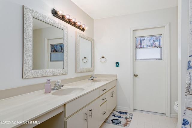 265 Sheridan Ave, Satellite Beach, FL 32937 - bathroom featuring double vanity, toilet, a sink, and tile patterned floors