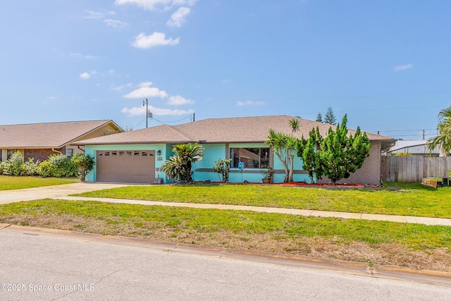 265 Sheridan Ave, Satellite Beach, FL 32937 - single story home with concrete driveway, an attached garage, fence, and a front lawn