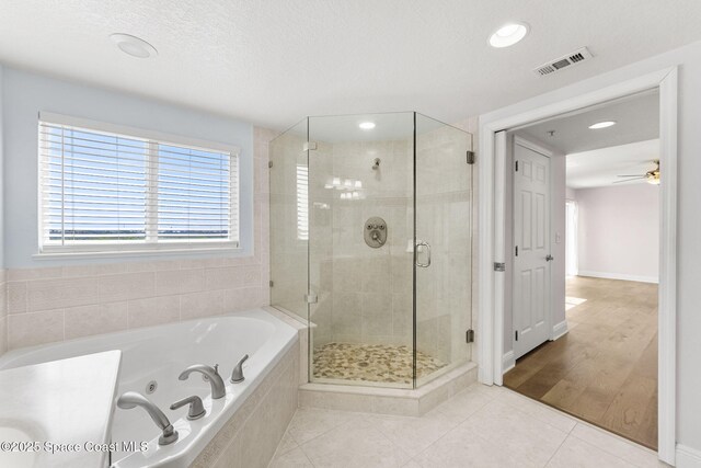 551 Casa Bella Dr Unit 501, Cape Canaveral, FL 32920 - full bathroom featuring a jetted tub, a shower stall, tile patterned flooring, recessed lighting, and a ceiling fan