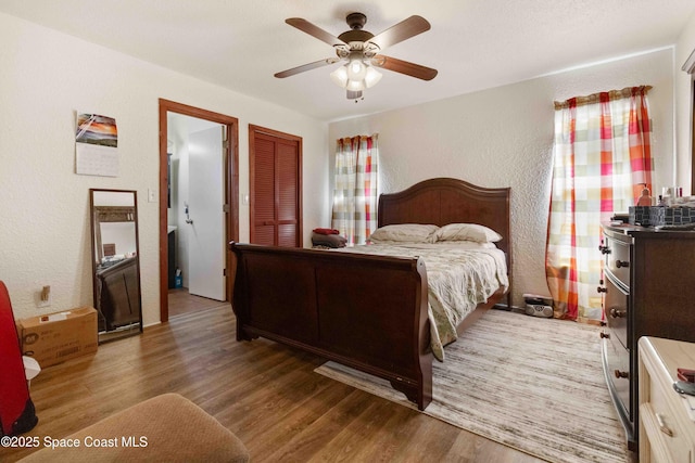 1019 Lee Ave NW, Palm Bay, FL 32907 - bedroom featuring wood finished floors, a textured wall, a closet, and a ceiling fan